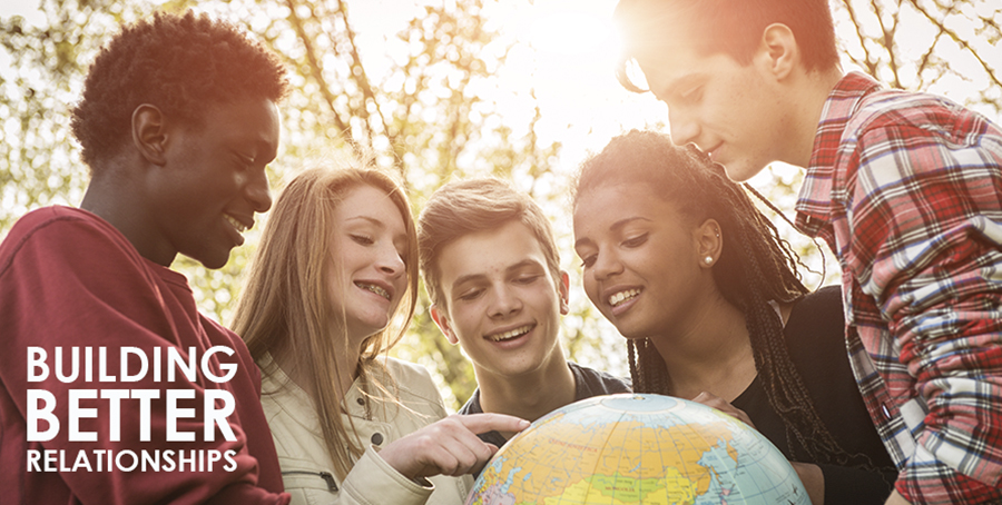 Teenagers exploring a globe of the world