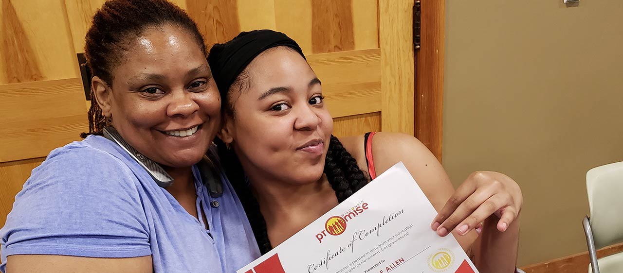 mother and daughter proudly holding Promise Wisconsin certificate